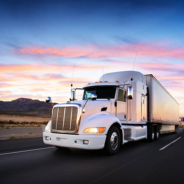 istock Truck and highway at sunset - transportation background 520703819