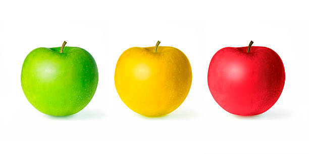 istock Three green red and yellow apples isolated on white background 520704051