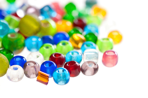 Close-up of a group of various colorful gemstones on white background.
