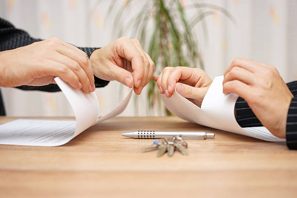 Husband and wife are tearing divorce papers stock photo