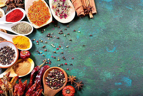 istock various spices in spoons on old green background 520707686