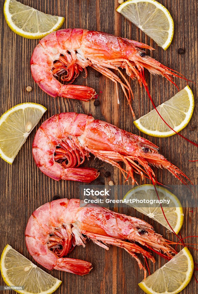 Grilled shrimps with lemon Grilled  shrimps with lemon on the wooden table Arts Culture and Entertainment Stock Photo