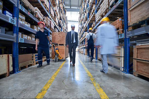 istock Coworkers walking box in warehouse aisle. 520709858