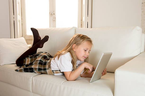 istock happy blond schoolgirl using internet app on digital tablet pad 520709994
