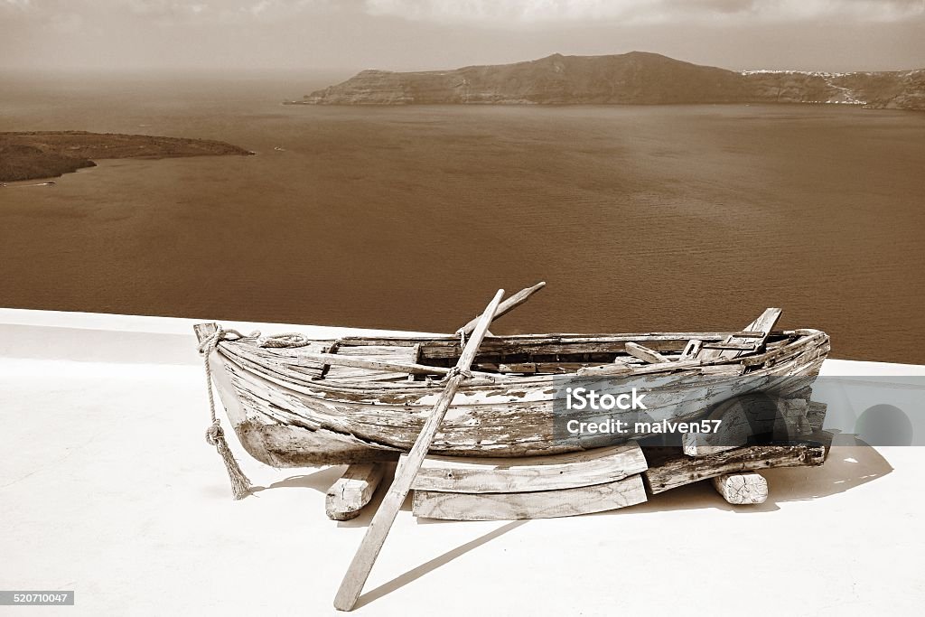 old wooden boat of tone sepia the one old wooden greek boat with oars of tone sepia and a sea landscape with islands on the horizon Abstract Stock Photo