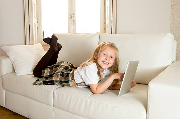 istock happy blond schoolgirl using internet app on digital tablet pad 520710508