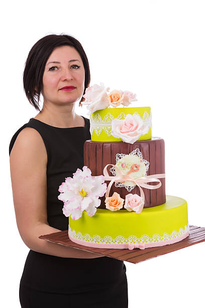 istock Aged woman holding a wedding cake. 520710888