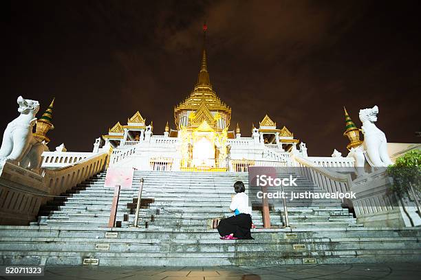 Praying Thai Woman At Wat Traimit In Night Stock Photo - Download Image Now - Adult, Architecture, Bangkok