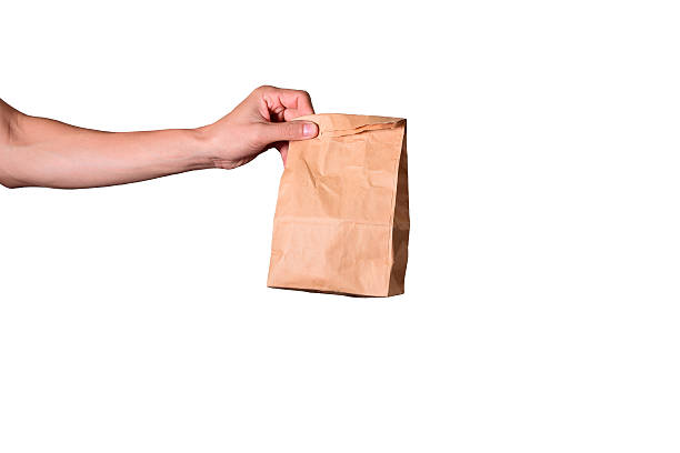 istock hand hold brown envelope isolated on white background, clipping path 520711429