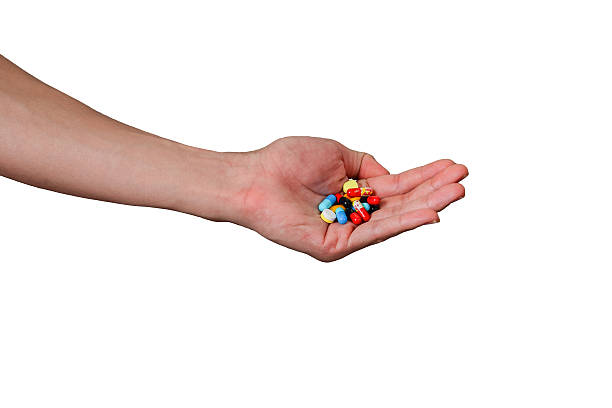 istock hand holding medicine pills isolated on white background 520711533