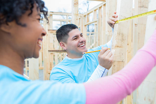 istock Happy volunteers work together on charity home 520711550