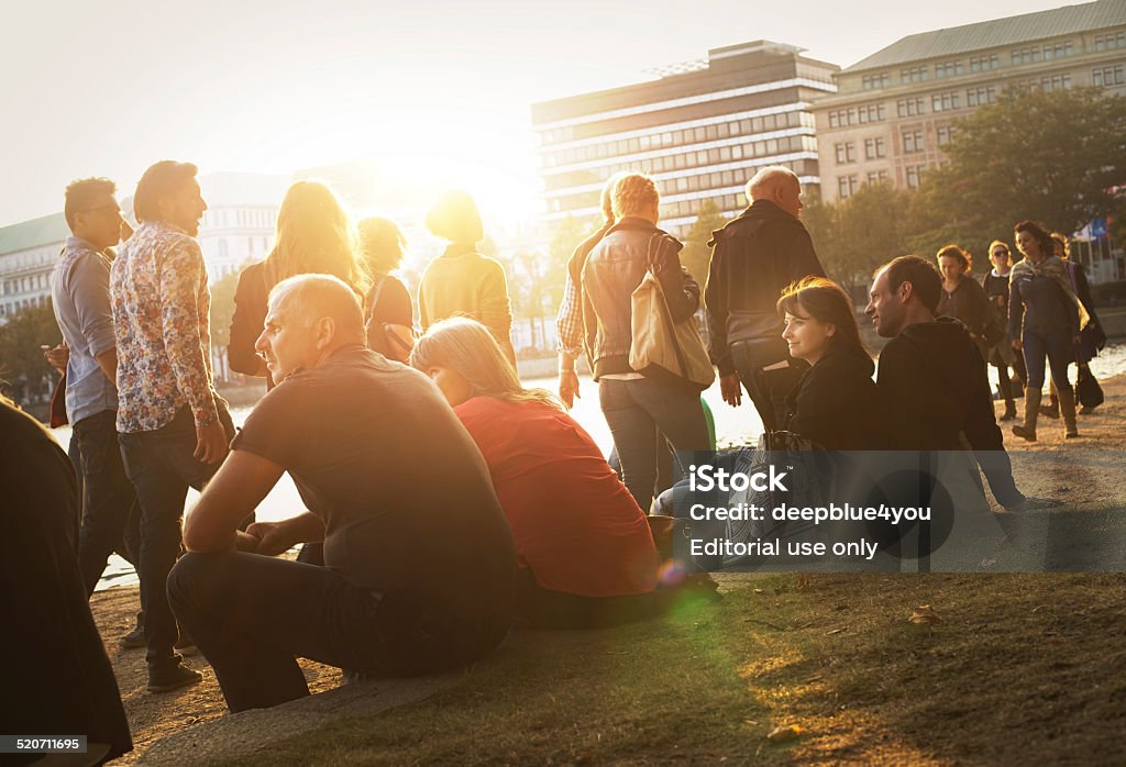 People on the alster lake Hamburg enjoy Hamburg, Germany - October 3, 2014: People sitting at the Binnenalster Hamburg, overlooking the Alster Lake at the late afternoon in sunshine Hamburg - Germany Stock Photo