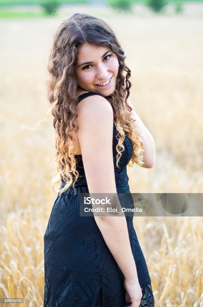 girl wheat smile black drees look camera Girl smiling in a field Adolescence Stock Photo