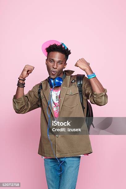 Studio Portrait Of Funky Excited Afro American Young Man Stock Photo - Download Image Now