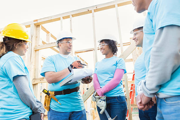 istock Attentive volunteers listen to construction foreman 520712930