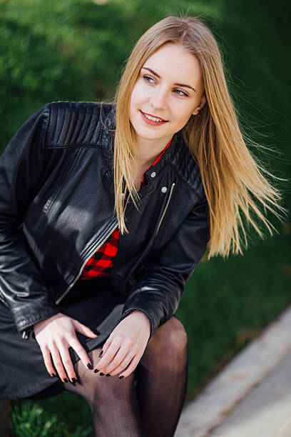 istock Young pretty girl sitting on the grass 520714944