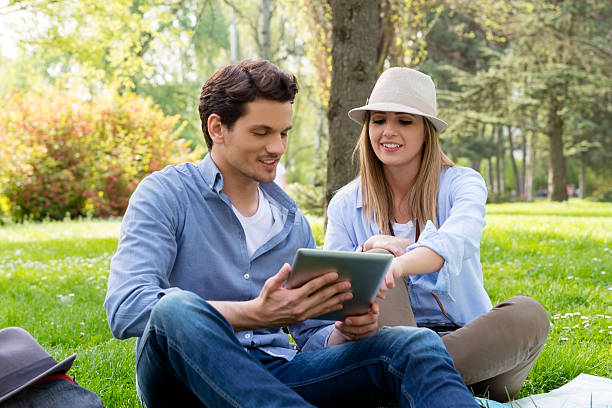 istock Young couple with tablet computer in the park 520715114