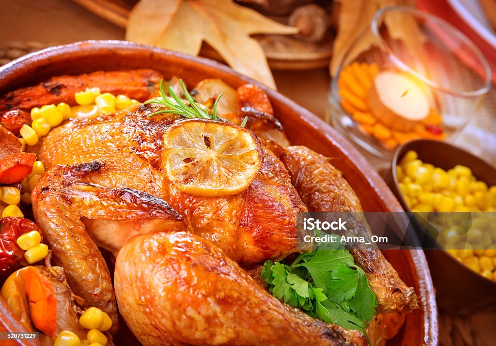 Thanksgiving day turkey Closeup on tasty roasted chicken with vegetables on the table, traditional food of Thanksgiving day, autumnal holiday concept Animal Stock Photo