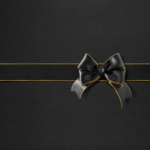 Photo of Double bow gold rimmed black ribbon on black gift paper