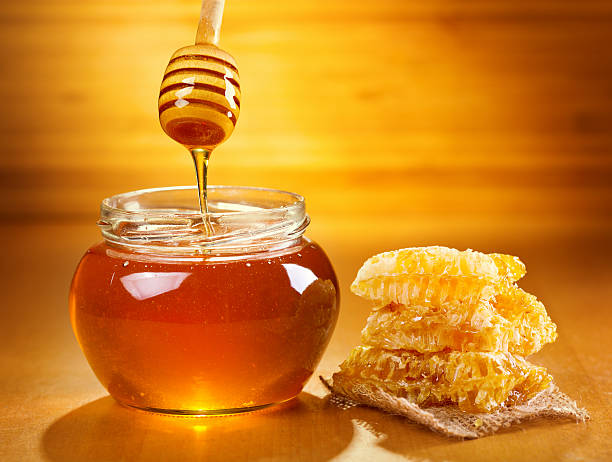 istock jar of honey with honeycomb 520733629