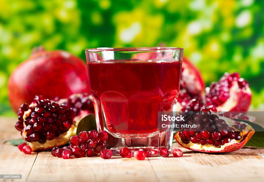 glass of pomegranate  juice with fresh fruits glass of pomegranate  juice with fresh fruits on wooden table Antioxidant Stock Photo