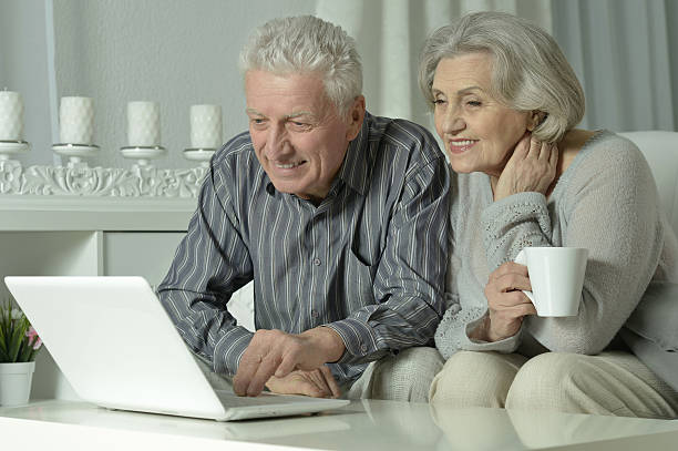 istock happy senior couple with laptop 520733702