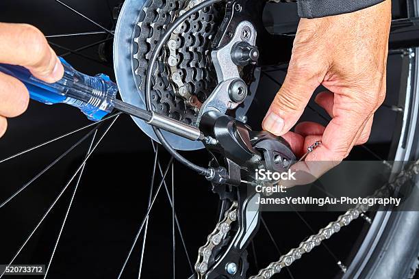 Man Adjusting Bicycle Derailleur Gear With Tools Closeup Stock Photo - Download Image Now