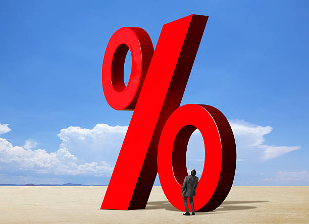 istock Businessman Looking Up At Percent Sign 520733933