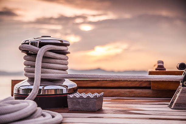 Rope Winch on Sailing Yacht Sunset A rope winch on a luxury sailing yacht.  cable winch stock pictures, royalty-free photos & images