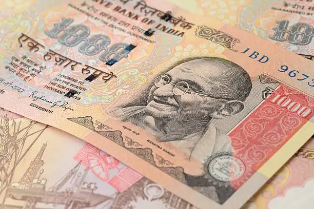 High Resolution Macro Shot of Indian Rupees One Thousand - 1000. This note or Paper Currency has the portrait of Mahatma Gandhi on the right side. It was first introduced by the Reserve Bank of India in 1954 and re-introduced in 2000. The image includes the Reserve Bank of India or  RBI stamp on the top.