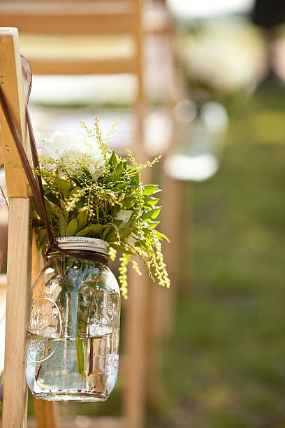 bouquet in jar at wedding stock photo