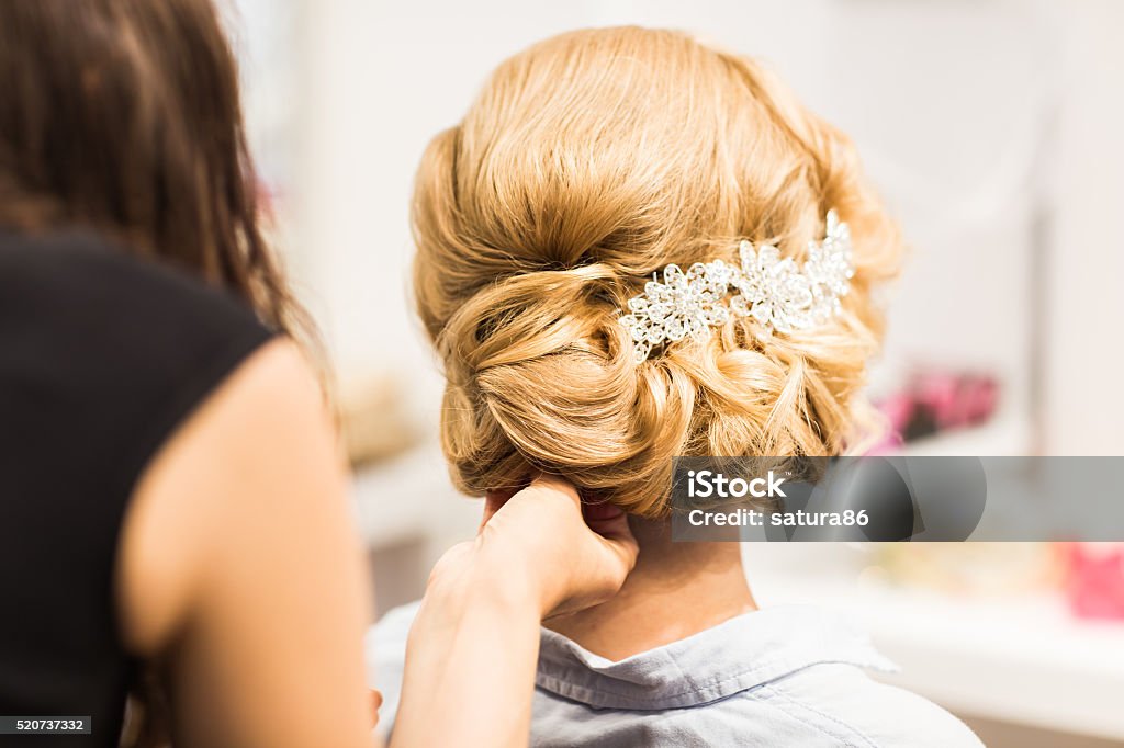 Portrait of attractive young woman with beautiful hairstyle and stylish Portrait of attractive young woman with beautiful hairstyle and stylish hair accessory, rear view Hair Clip Stock Photo