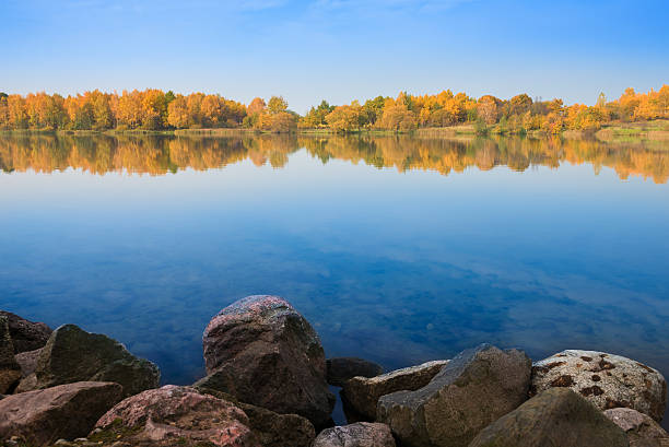 istock Autumn landscape, trees reflection in lake 520737785