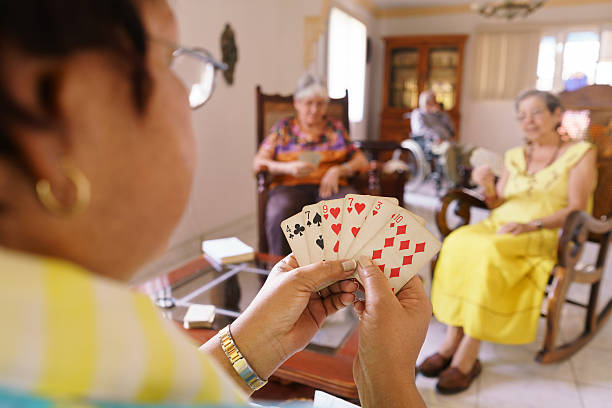 istock Old Women Have Fun Playing Card Game In Hospice 520741050