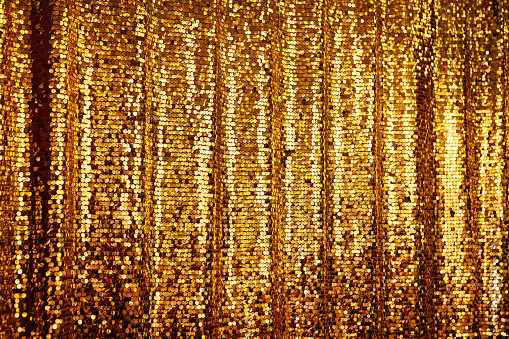 Abstract golden glitter background. Festive background with copyspace, hanging curtain