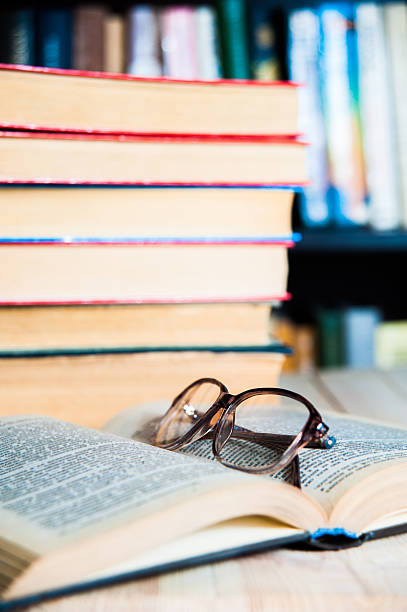 istock book and glasses on table in library 520741878