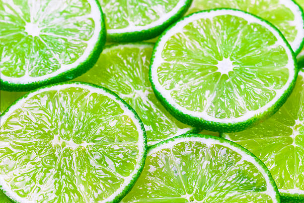 istock Green background with citrus-fruit of lime slices 520745800