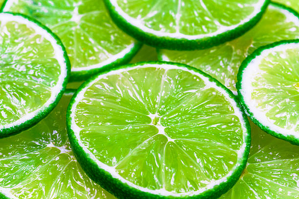istock Green background with citrus-fruit of lime slices 520746156