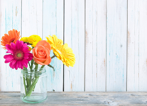 Assorted flowers over a wooden background