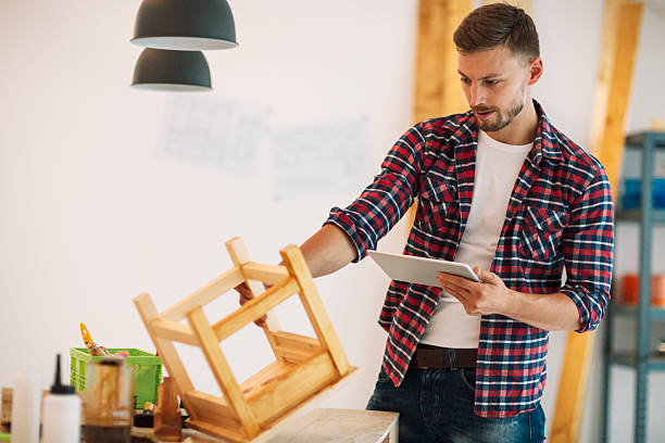 istock Carpenter Using Digital Tablet In His Furniture Workshop. 520747636