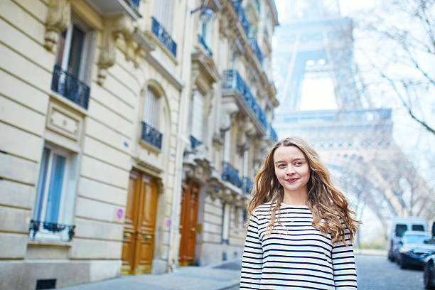 istock Young girl near the Eiffel tower, in Paris 520748040