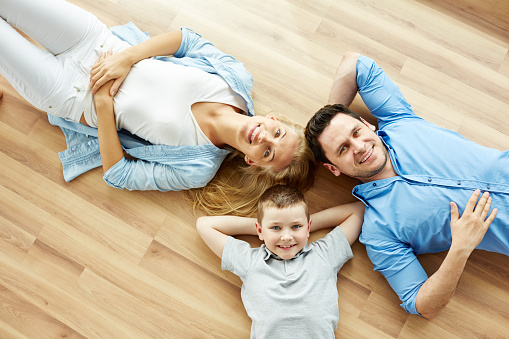 High angle view of charming family lying on floor