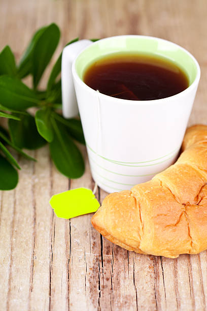 istock cup of tea and fresh croissant on 520751577