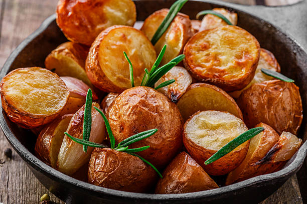 istock baked potatoes in a pan with rosemary 520753041