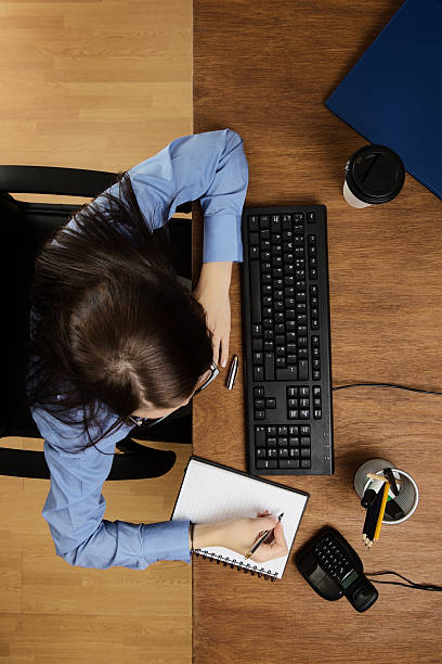 istock woman working at desk shot from above 520753101