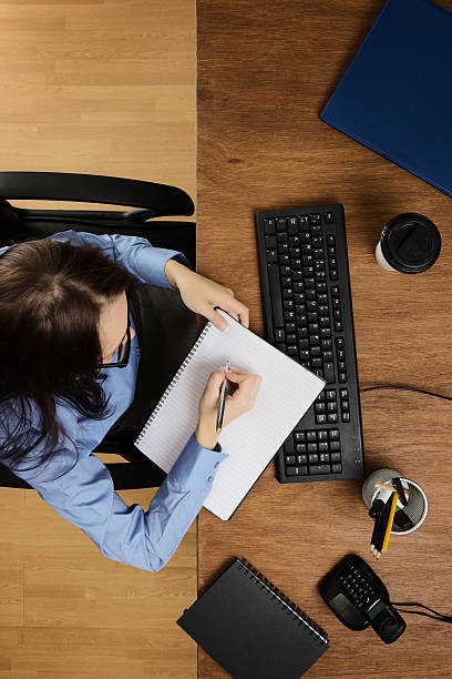 istock woman working at desk shot from above 520753121