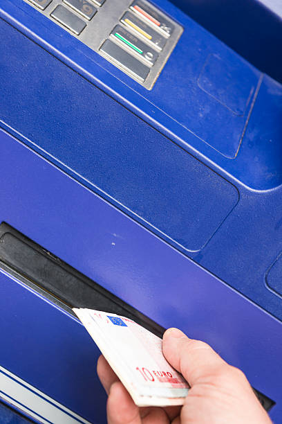 istock Withdrawing money from ATM 520754081