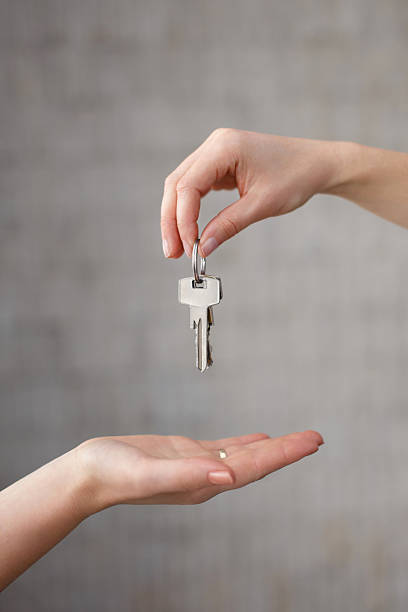 istock Hand giving keys to another hand 520756379