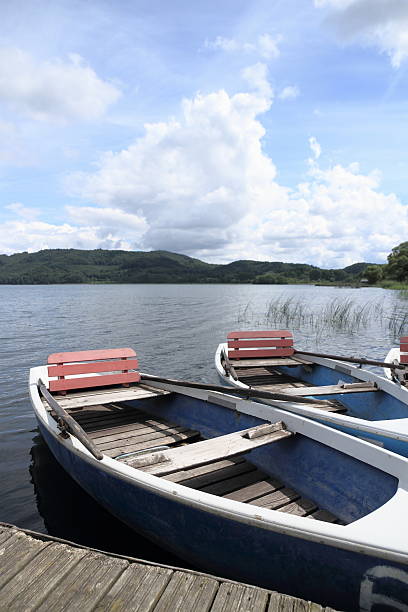 istock Two row boats at pier on lake 520756643