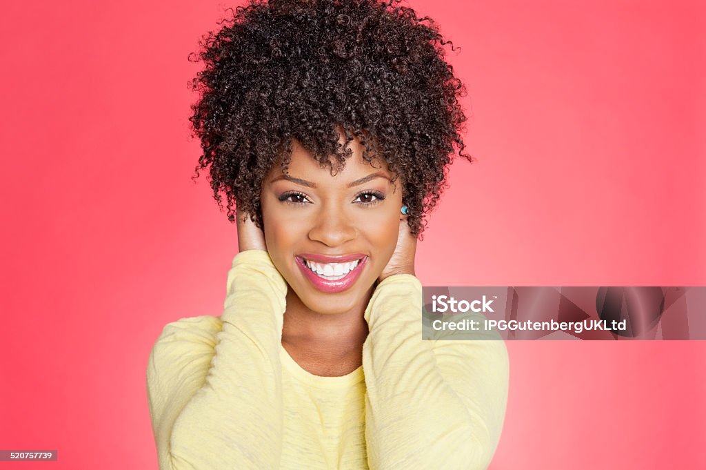 Portrait of an African American woman Portrait of a cheerful African American woman with hands over ears Curly Hair Stock Photo